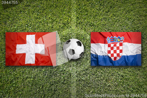 Image of Switzerland vs. Croatia flags on soccer field