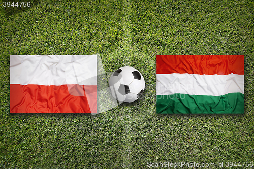 Image of Poland vs. Hungary flags on soccer field