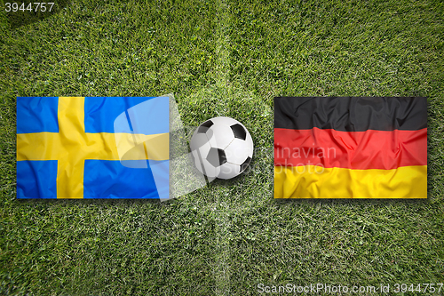 Image of Sweden vs. Germany flags on soccer field