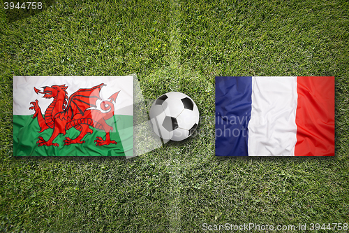 Image of Wales vs. France flags on soccer field