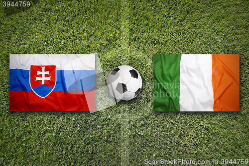 Image of Slovakia vs. Ireland flags on soccer field