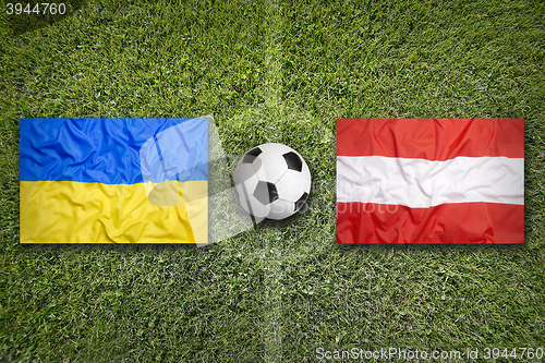 Image of Ukraine vs. Austria flags on soccer field