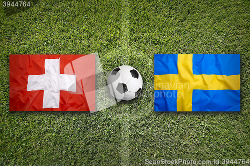 Image of Switzerland vs. Sweden flags on soccer field
