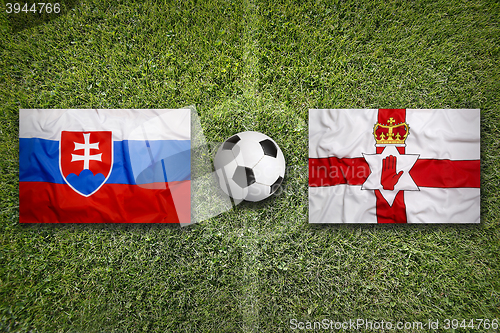 Image of Slovakia vs. Northern Ireland flags on soccer field