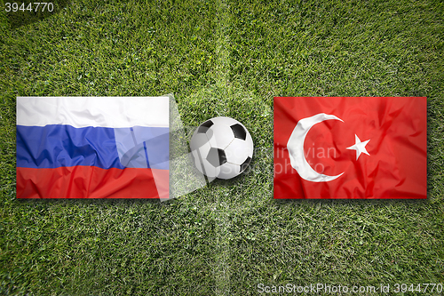 Image of Russia vs. Turkey flags on soccer field