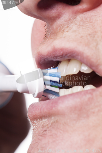 Image of Close up of electric toothbrush and paste on white