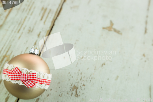 Image of Three Christmas baubles on rustic wood