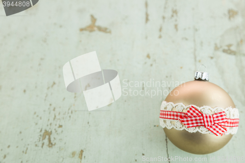 Image of Three Christmas baubles on rustic wood