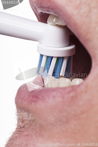 Image of Close up of electric toothbrush and paste on white