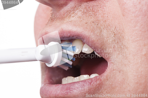 Image of Close up of electric toothbrush and paste on white