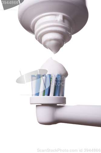 Image of Close up of electric toothbrush and paste on white