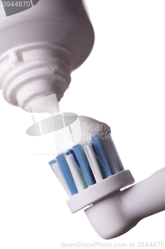 Image of Close up of electric toothbrush and paste on white