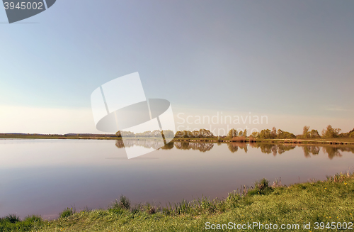 Image of A large beautiful lake, with banks overgrown with reeds.