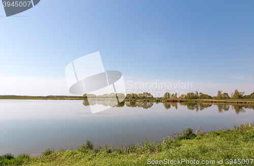 Image of A large beautiful lake, with banks overgrown with reeds.