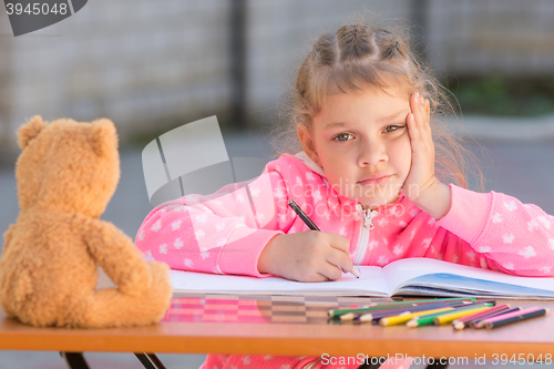 Image of The girl does not know how to continue to draw drawing pencils