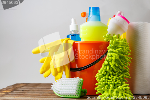 Image of Bucket with cleaning items on light background