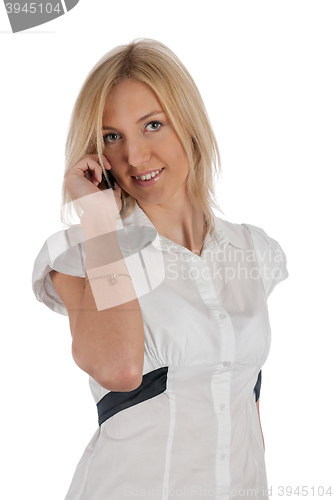 Image of Beautiful blonde girl talking on phone and smiling