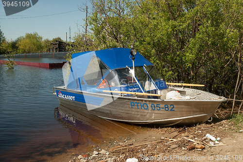 Image of Motor boat and spring flooding in Russian village