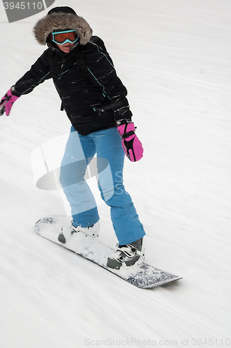 Image of Woman doing exercise on snowboard