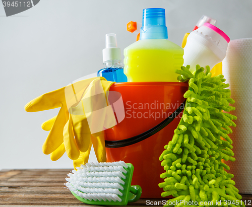 Image of Bucket with cleaning items on light background