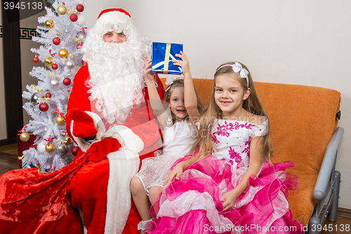 Image of Santa Claus presented the first gift girls