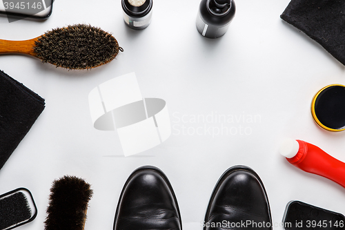 Image of Cleaning boots concept on white background