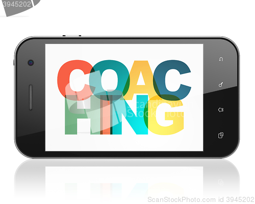 Image of Education concept: Smartphone with Coaching on  display