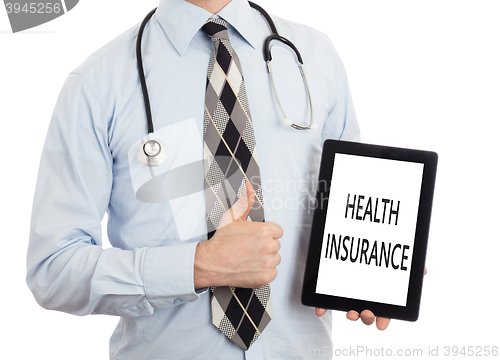 Image of Doctor holding tablet - Health insurance