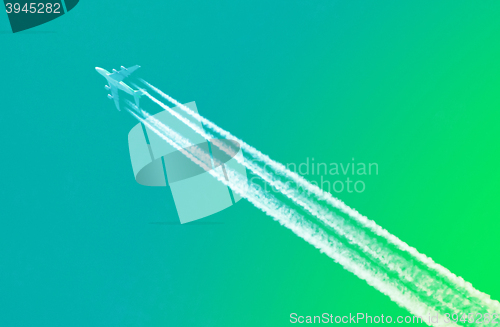 Image of Plane in blue sky - Bright green sky
