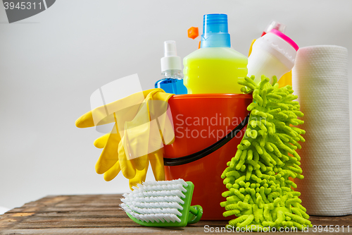 Image of Bucket with cleaning items on light background