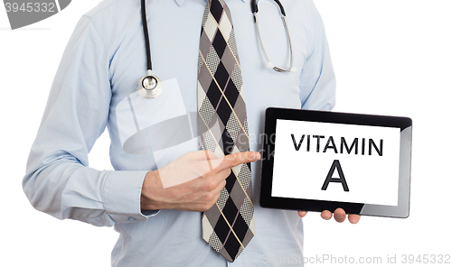 Image of Doctor holding tablet - Vitamin A