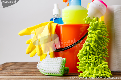 Image of Bucket with cleaning items on light background