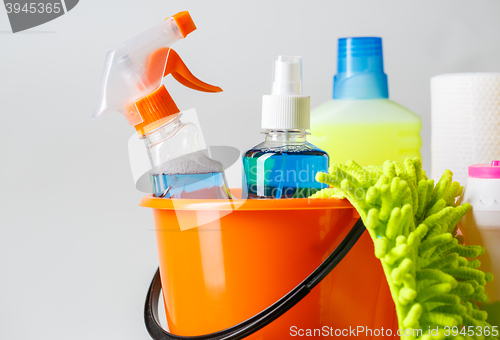 Image of Bucket with cleaning items on light background