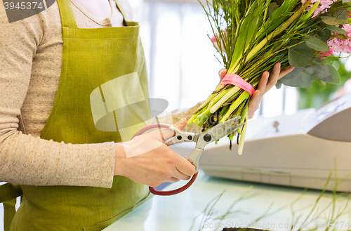 Image of close up of woman making bunch at flower shop