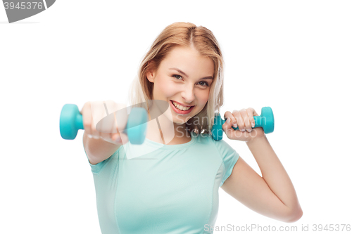 Image of smiling beautiful young sporty woman with dumbbell