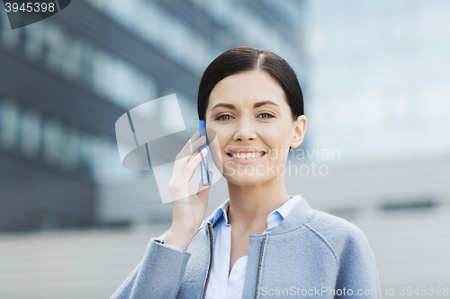 Image of young smiling businesswoman calling on smartphone