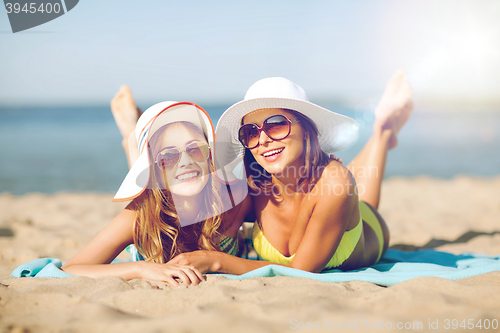 Image of girls sunbathing on the beach