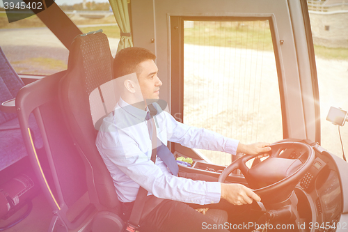 Image of happy driver driving intercity bus