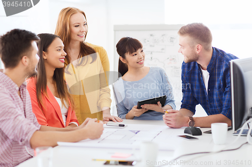 Image of happy creative team or students working at office