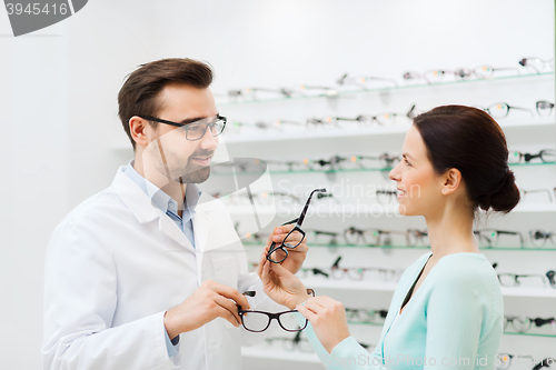 Image of woman and optician showing glasses at optics store