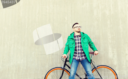 Image of happy young hipster man with fixed gear bike