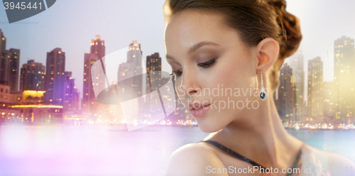 Image of beautiful young asian woman with earring in city