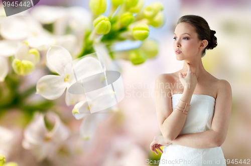 Image of beautiful asian woman with golden bracelet