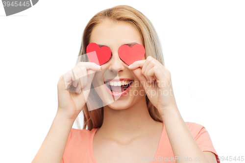 Image of happy young woman with red heart shapes on eyes