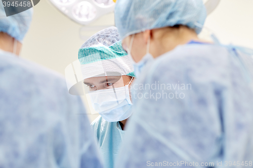 Image of group of surgeons in operating room at hospital