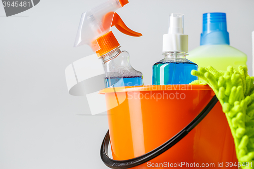 Image of Bucket with cleaning items on light background