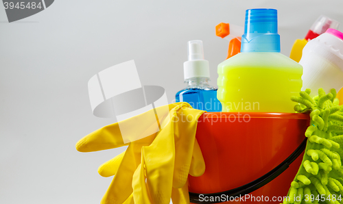 Image of Bucket with cleaning items on light background