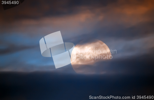 Image of Full moon behind clouds