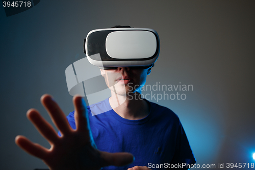 Image of Man wearing virtual reality goggles.