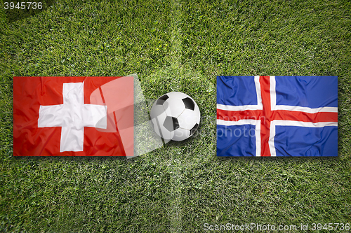 Image of Switzerland vs. Iceland flags on soccer field
